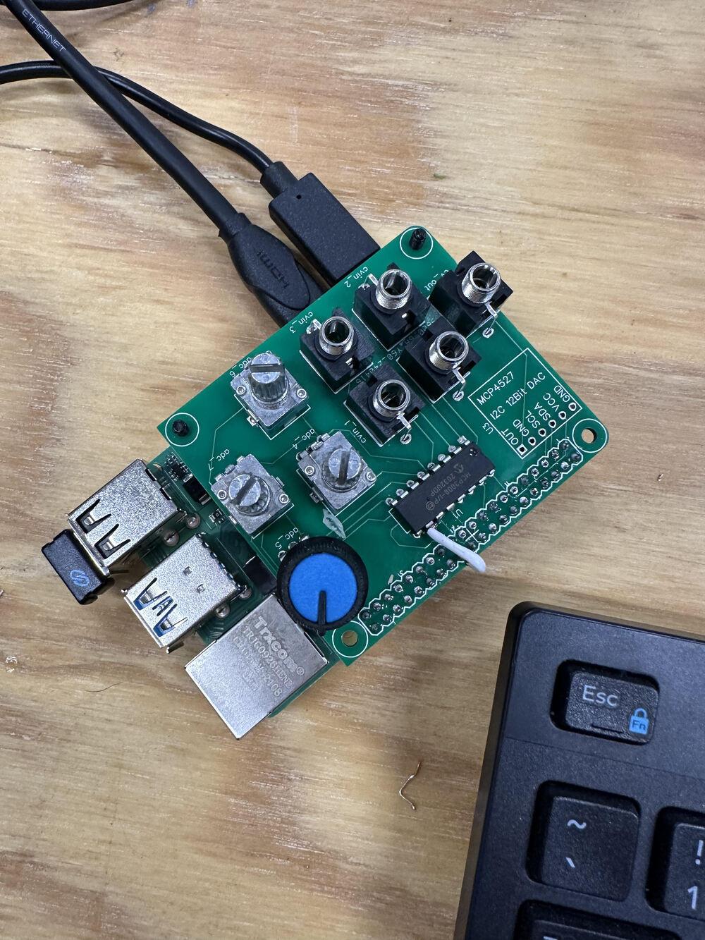 overhead shot of Rasperry Pi with custom hat prototype. No knobs fitted, with hdmi and power plugged in